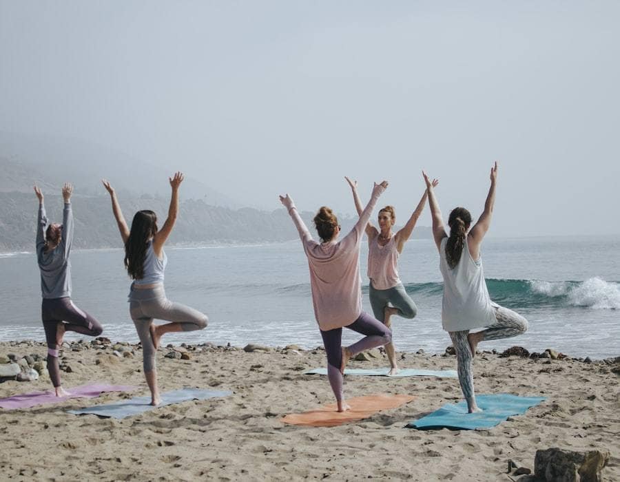 A small group doing a guided exercise together on a beach